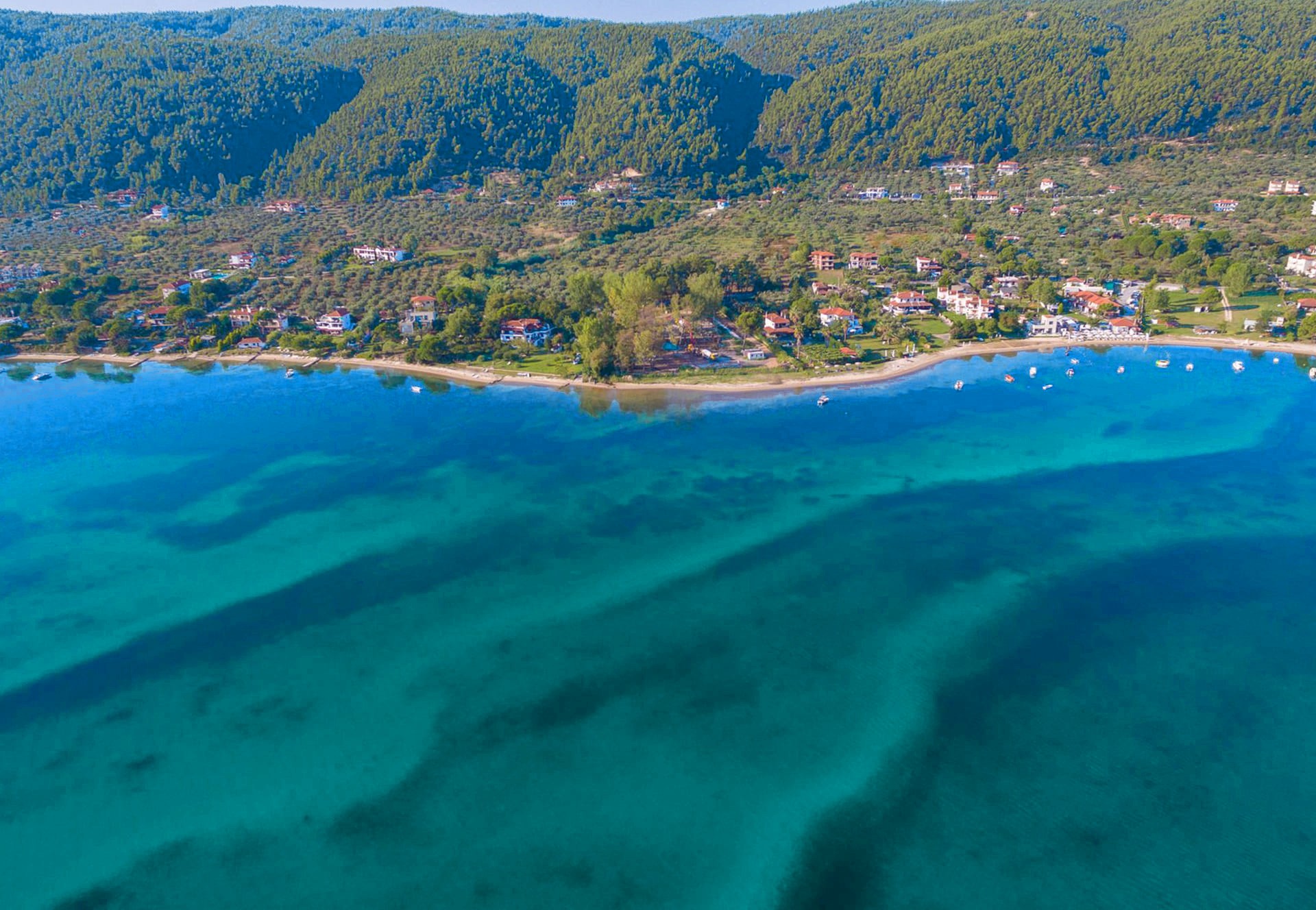 Vourvourou bay with turquoise water and pine-covered hills, Sithonia